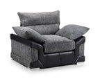 Modern grey corduroy and black leather armchair with plush cushions on a white background.