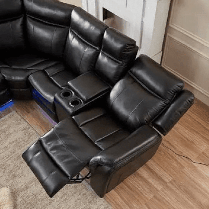 Black leather recliner corner sofa with LED lights and cup holders in a modern living room