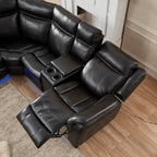 Black leather recliner corner sofa with LED lights and cup holders in a modern living room