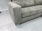 Modern U-shaped grey fabric sofa with plush cushions on light wood flooring