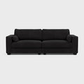 Large modern black fabric sofa with wide armrests and clean lines on a light background