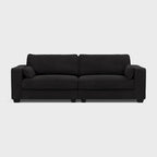 Large modern black fabric sofa with wide armrests and clean lines on a light background