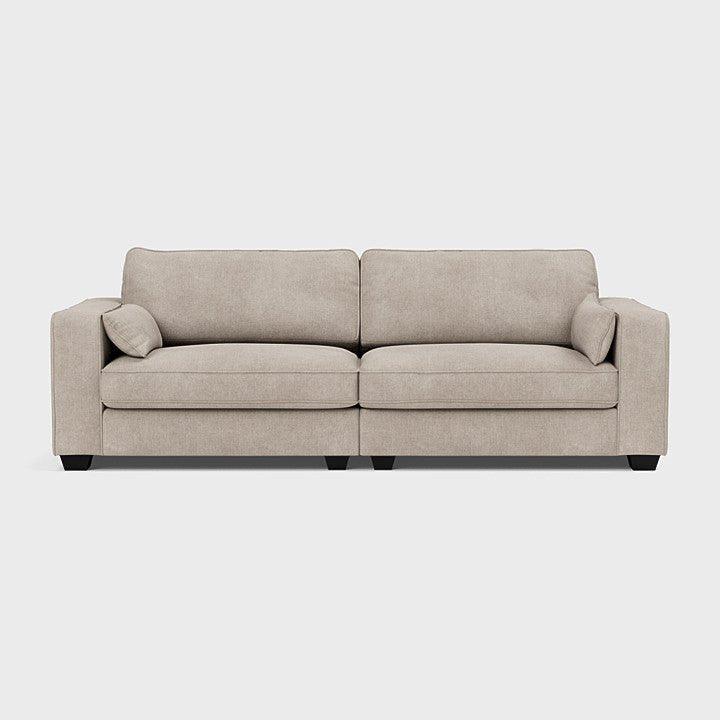 Large beige fabric sofa with square arms and two cushions on a plain background