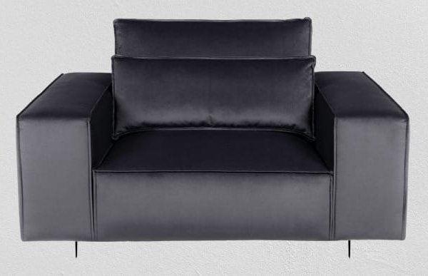Modern grey armchair with wide arms and plush cushions on a light background