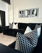 Modern black modular corner sofa with geometric throw pillows in stylish living room