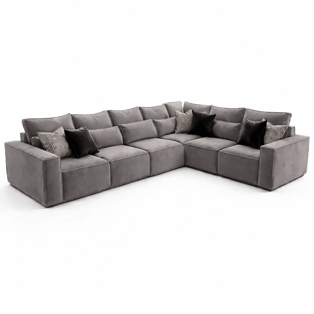 Large grey modular corner sofa with plush seat cushions and black accent pillows