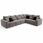 Large grey modular corner sofa with plush seat cushions and black accent pillows