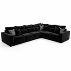 Large black modular corner sofa with plush cushions and accent pillows, modern living room seating.