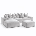 Large silver velvet corner sofa with pillow back and matching ottoman on white background