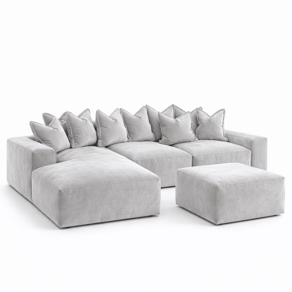 Large silver velvet corner sofa with pillow back and matching ottoman on white background