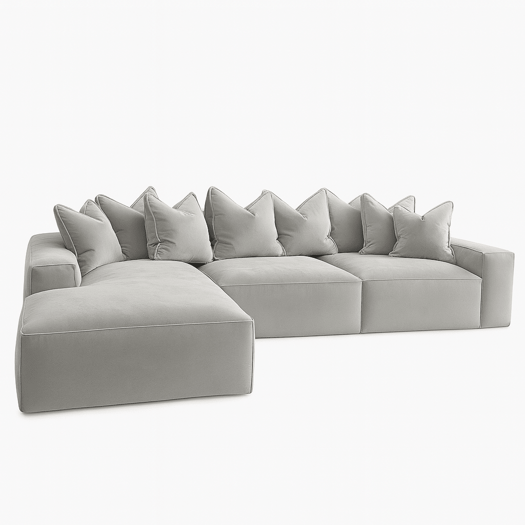 Large silver velvet pillow back sectional sofa with left-hand chaise on white background