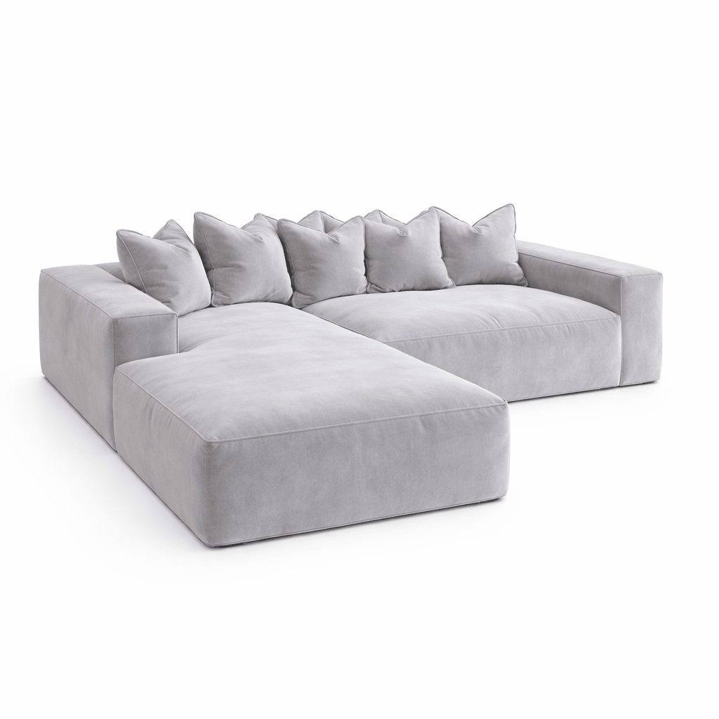Large silver velvet sectional sofa with pillow back and left-hand chaise on white background