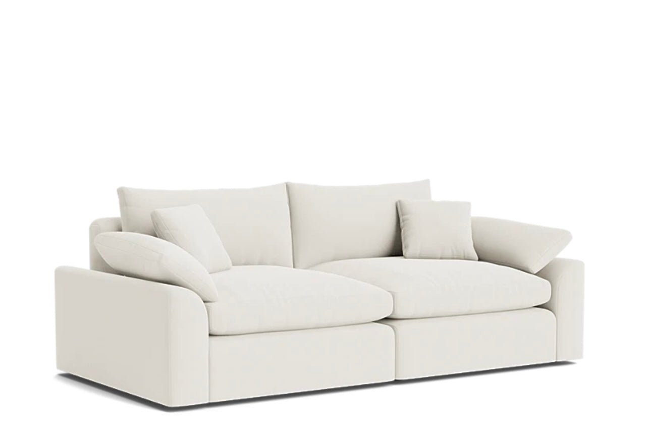 Cream modular sofa with plush cushions and wide arms, ideal for modern living room decor