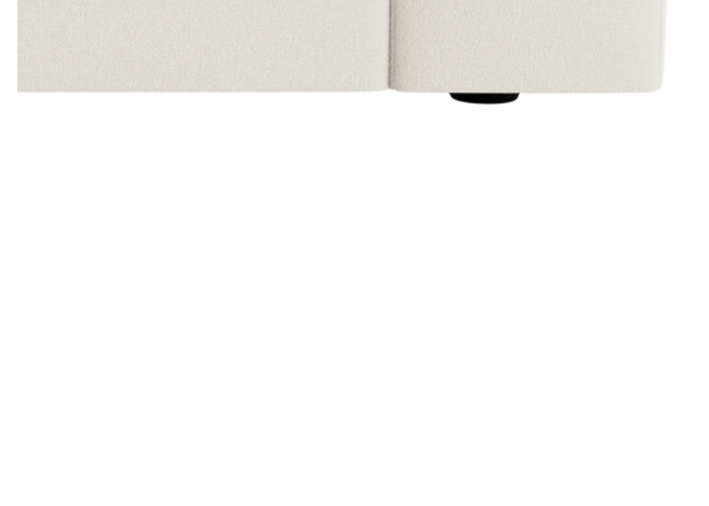 Close-up of cream modular sofa base with textured upholstery and low black feet