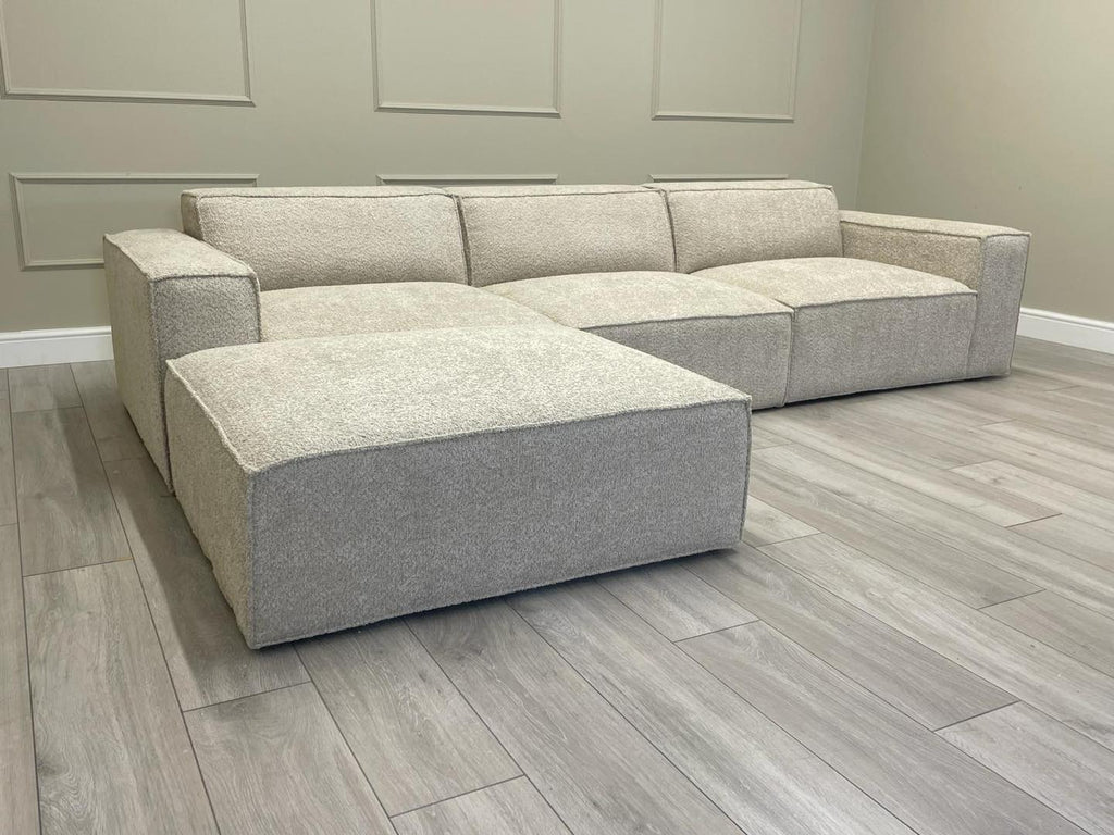 Ivory modular cinema sofa with removable footstool on grey wood floor in modern room