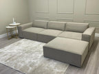 Ivory corner cinema sofa with removable footstool on a light rug and modern accent tables