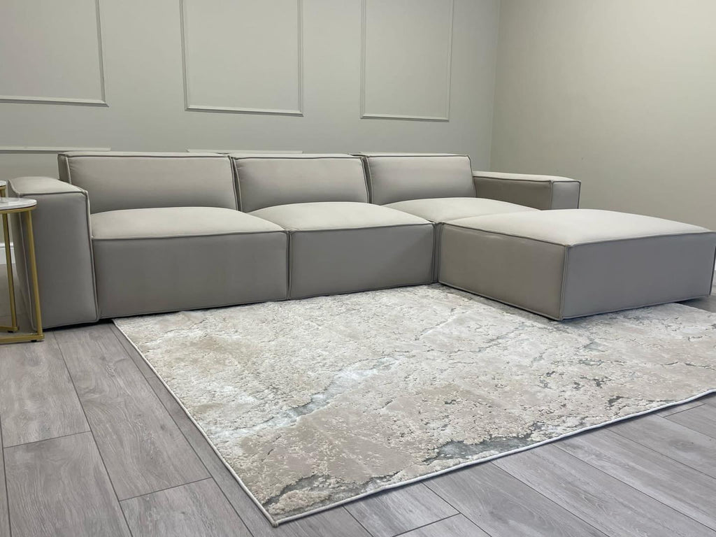 Ivory modular cinema sofa with removable footstool in a modern living room setting