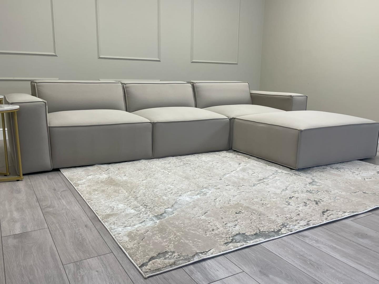 Ivory modular cinema sofa with removable footstool in a modern living room setting
