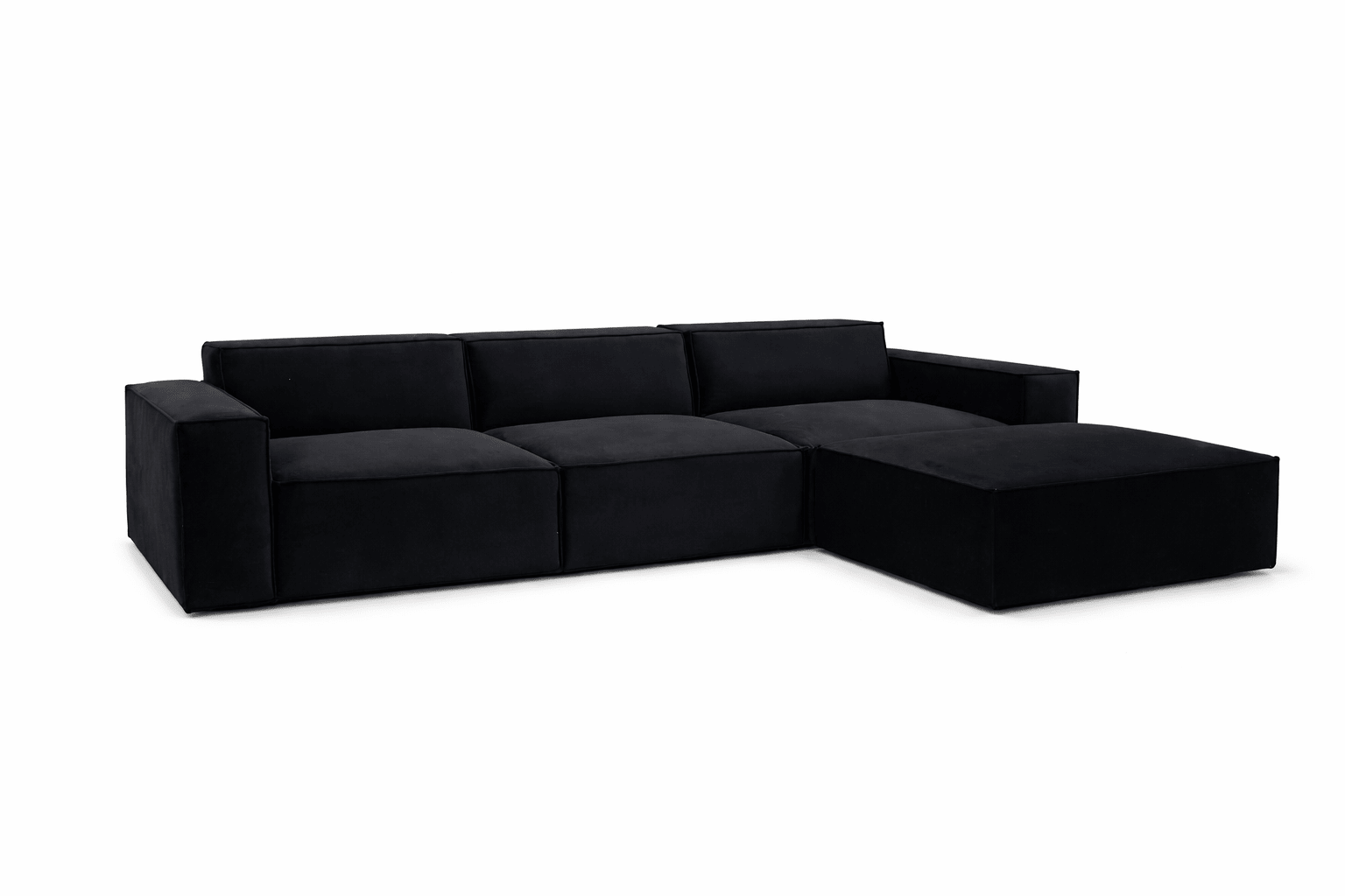 Black modular cinema sofa with wide arms and a matching removable footstool on white background