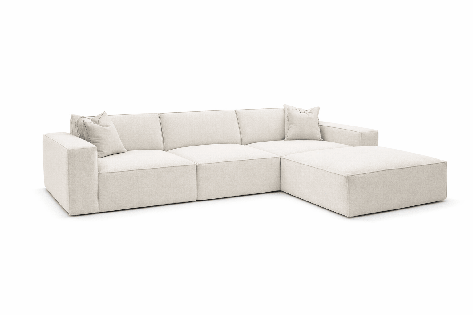 Ivory corner cinema sofa with wide armrests, two scatter cushions and a removable footstool