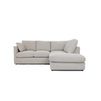 Modern cream right corner sofa with plush cushions and chaise lounge, isolated on white background