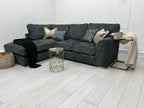 Luxury dark grey corner sofa with scatter cushions in a modern living room setting