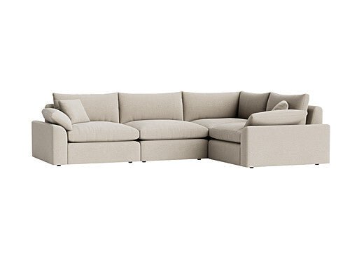 Beige modular corner sofa with plush cushions and low armrests, modern living room furniture.