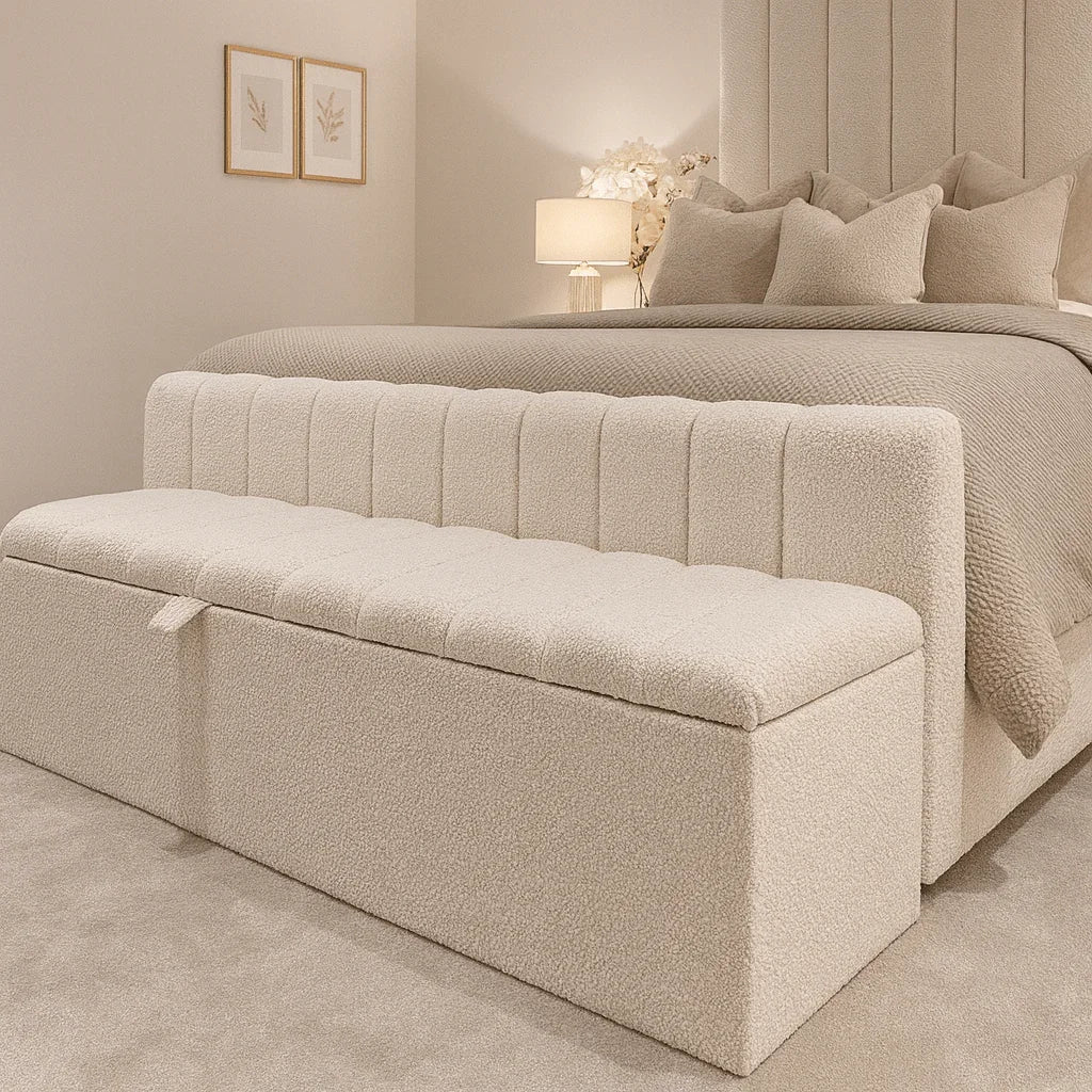 Cream bouclé storage bench at foot of luxury bed, matching headboard and bedding for cozy bedroom