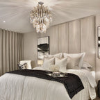 Cream velvet upholstered headboard wall panels behind a modern bed in an elegant bedroom.