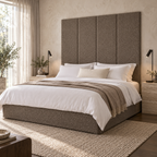 Four Pebble Teddy 45cm wall panels behind a matching upholstered bed base in a styled bedroom. Room visualisation; panels sold individually, base and styling separate.