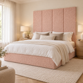 Four Powder Teddy 45cm wall panels behind a matching upholstered bed base in a styled bedroom. Room visualisation; panels sold individually, base and styling separate.