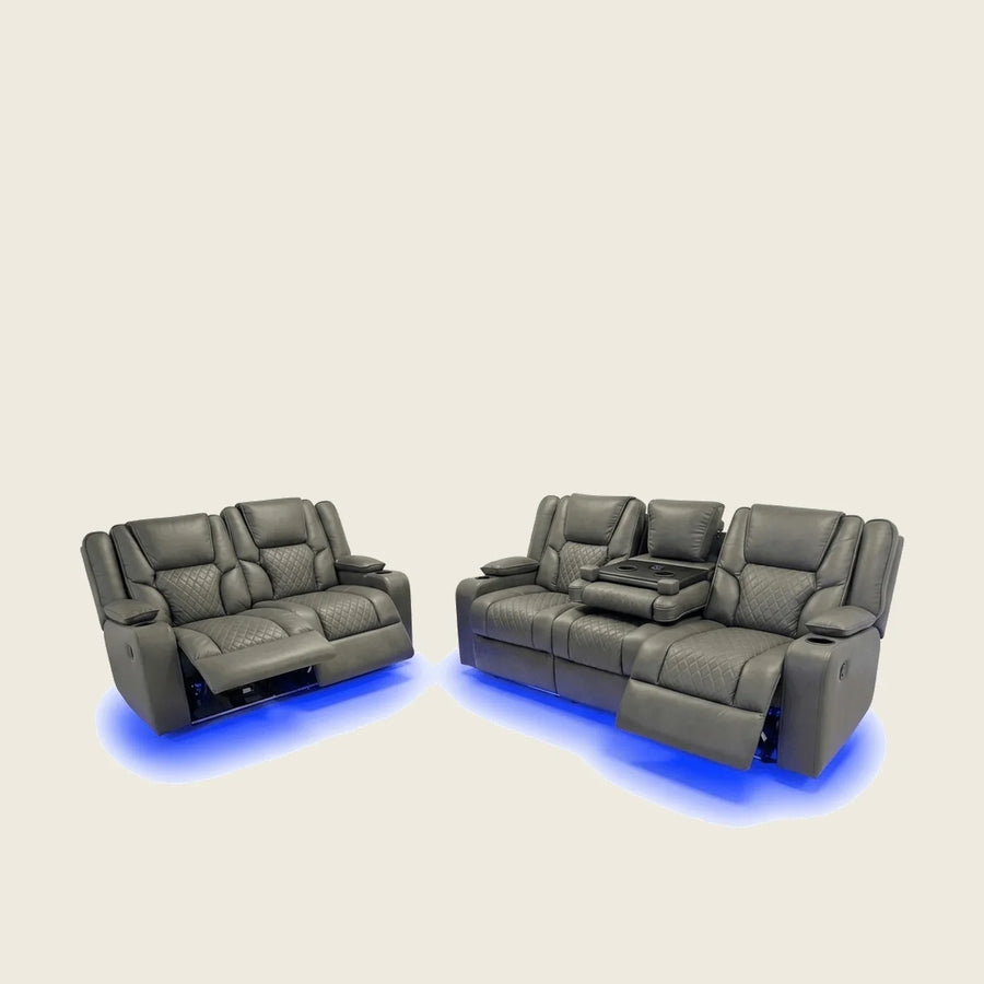 Luxury grey recliner sofas with quilted upholstery, cup holders, and blue LED lighting for home cinema comfort.
