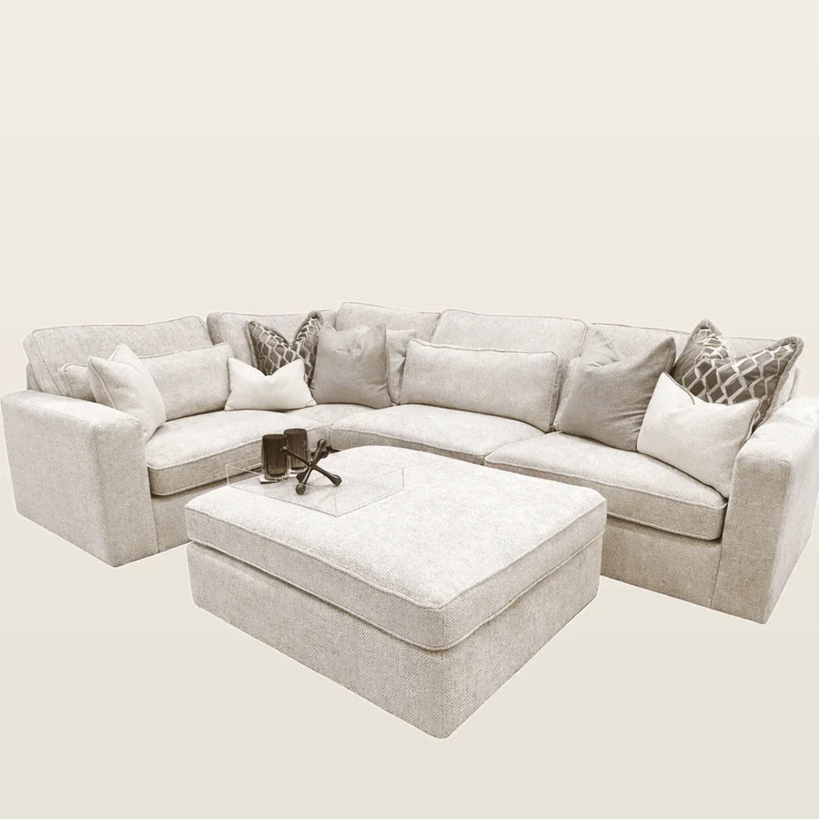 Luxury beige sectional sofa with matching ottoman and decorative pillows, perfect for modern living rooms.