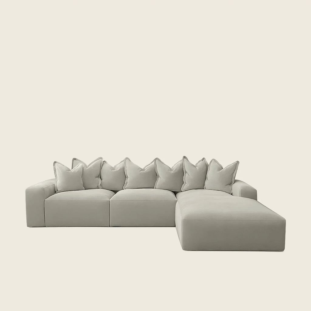Luxury grey sectional sofa with chaise lounge and plush pillows, modern living room furniture