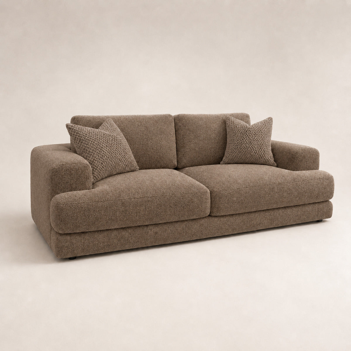 Aurelia 3 Seater Sofa in Coffee on a clean stone studio background