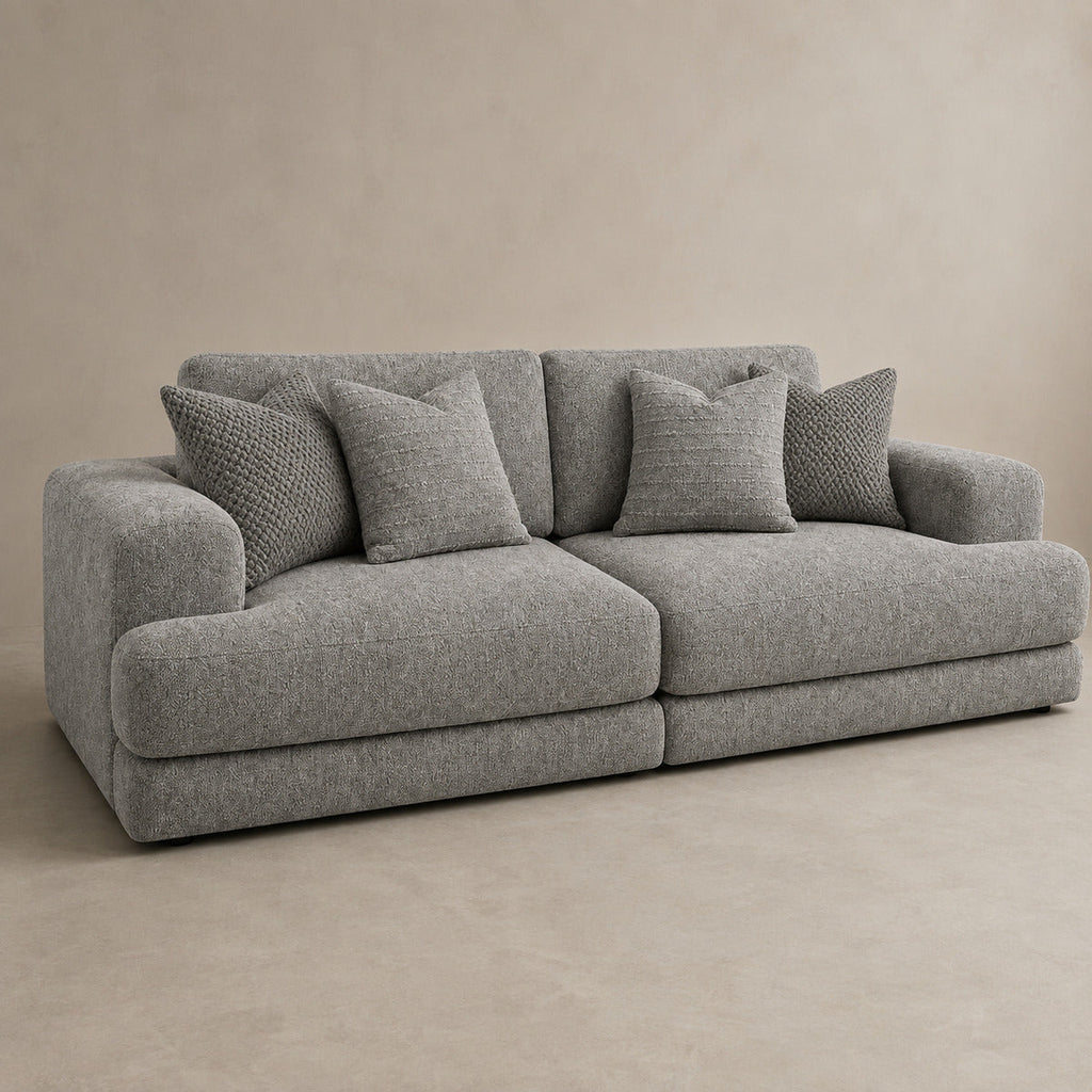 Aurelia 4 Seater Split Sofa in Luxe Steel Grey on a clean stone studio background