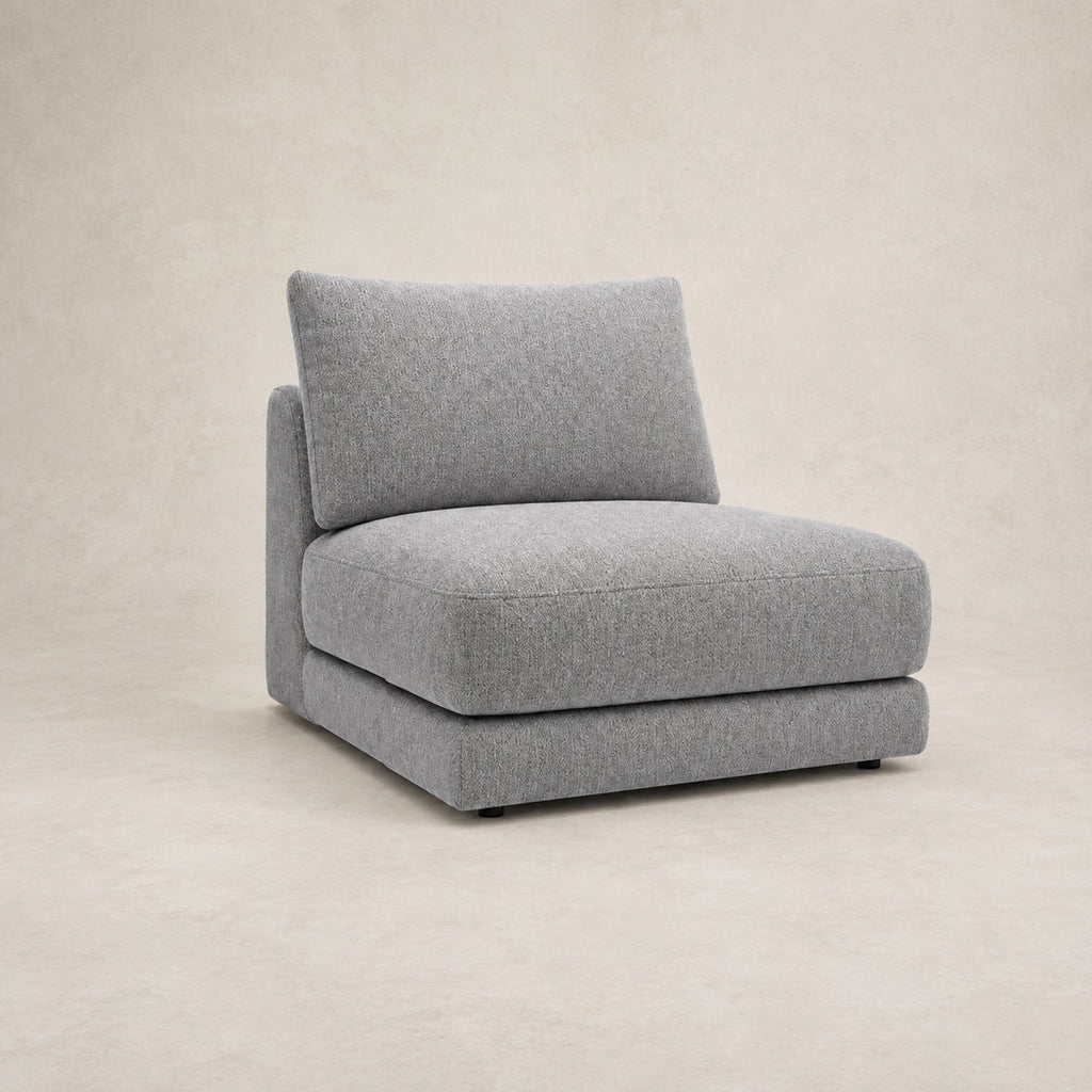 Aurelia Armless Module in Luxe Steel Grey on a clean stone studio background