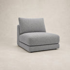 Aurelia Armless Module in Luxe Steel Grey on a clean stone studio background