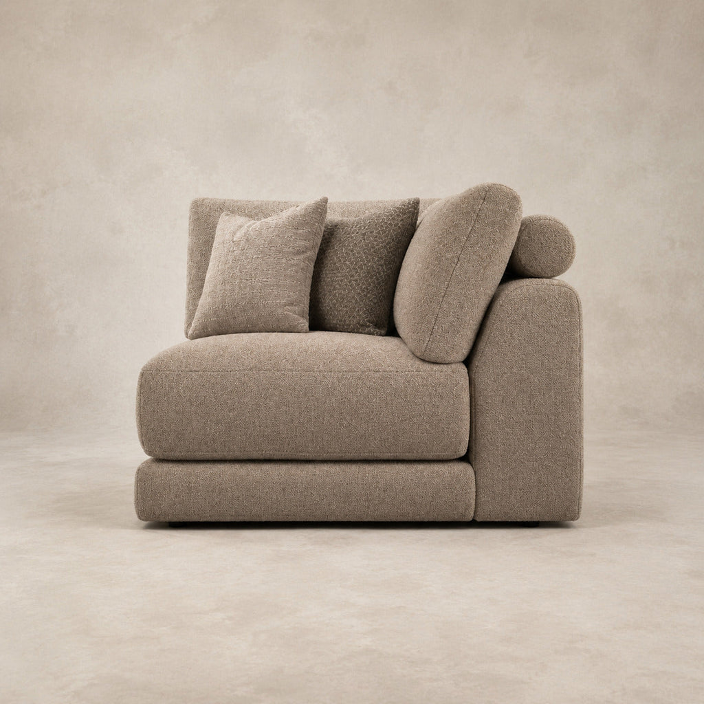 Aurelia Corner Module in Coffee on a clean stone studio background