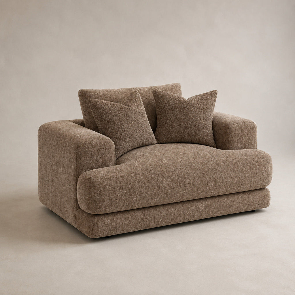 Aurelia Cuddler Love Seat in Coffee on a clean stone studio background