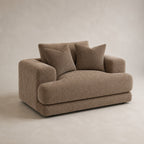 Aurelia Cuddler Love Seat in Coffee on a clean stone studio background