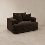 Aurelia Cuddler Love Seat in Double Espresso on a clean stone studio background