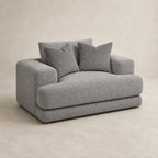 Aurelia Cuddler Love Seat in Luxe Steel Grey on a clean stone studio background