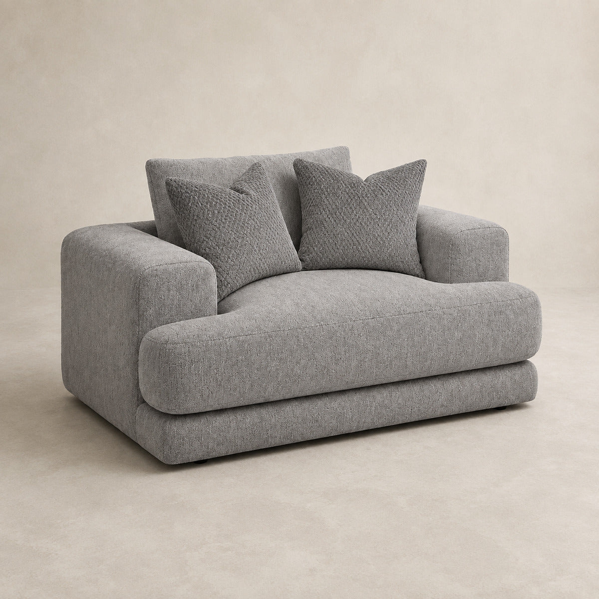 Aurelia Cuddler Love Seat in Luxe Steel Grey on a clean stone studio background