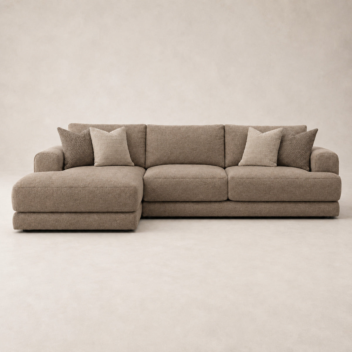Aurelia Large Chaise Sofa in Coffee on a clean stone studio background