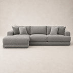 Aurelia Large Chaise Sofa in Luxe Steel Grey on a clean stone studio background