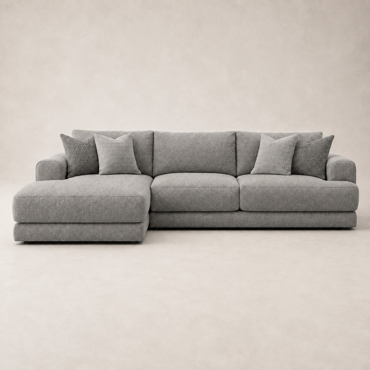 Aurelia Large Chaise Sofa in Luxe Steel Grey on a clean stone studio background