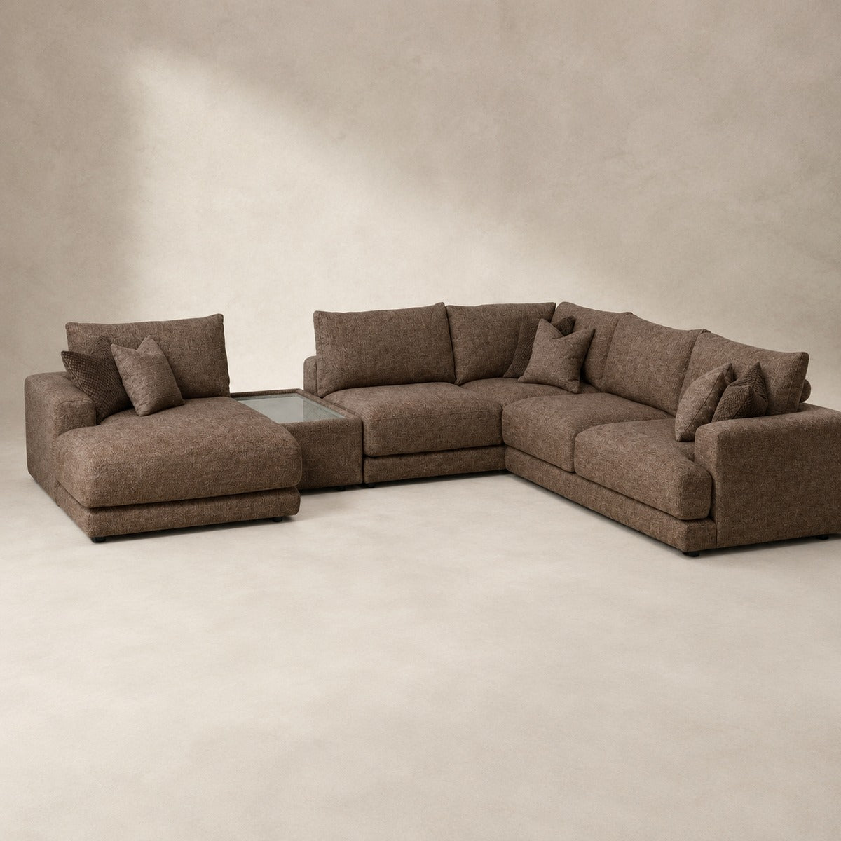 Aurelia Large Chaise Sofa & Glass-Top Table Set in Coffee on a clean stone studio background