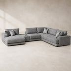 Aurelia Large Chaise Sofa & Glass-Top Table Set in Luxe Steel Grey on a clean stone studio background