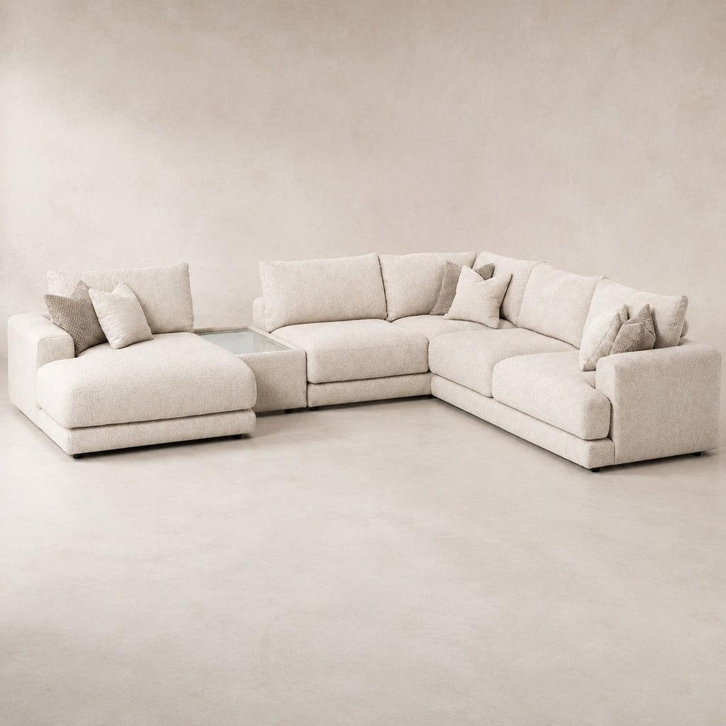 Aurelia Large Chaise Sofa & Glass-Top Table Set in Summer Beach on a clean stone studio background